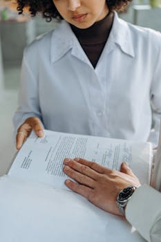 Close-up of hands analyzing a legal document in an office setting.